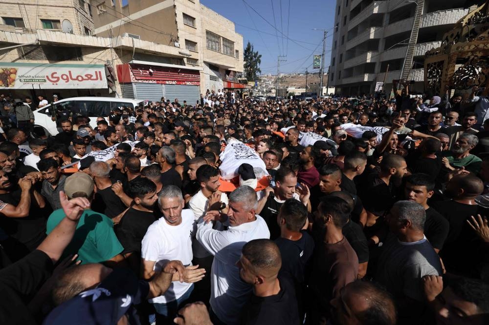 Raided West Bank city holds funerals after Israeli army withdraws