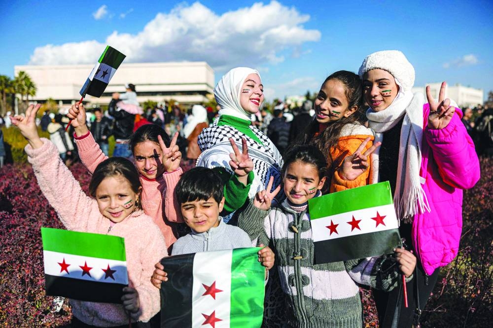 Thousands of Syrians celebrate in streets, calling for unity