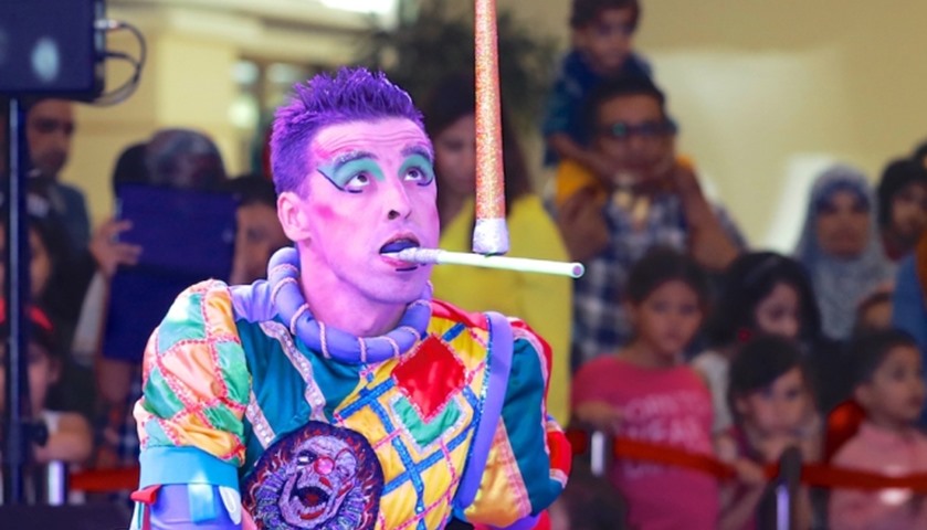 A performer entertains spectators with his balancing act