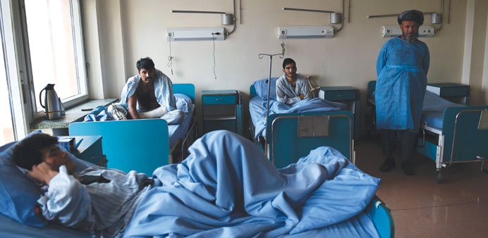 Wounded Afghan National Army soldiers sit on beds on a ward at Sardar Mohamed Daoud Khan Military Hospital in Kabul.