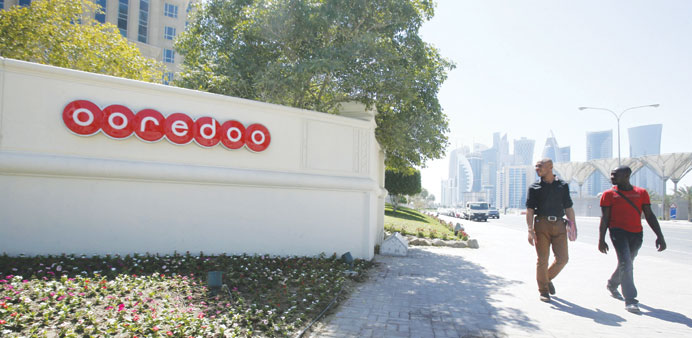 Men walk past Ooredoou2019s head office in Doha. In Qatar, Ooredoo will launch 4G services on data on MiFi within two weeks.