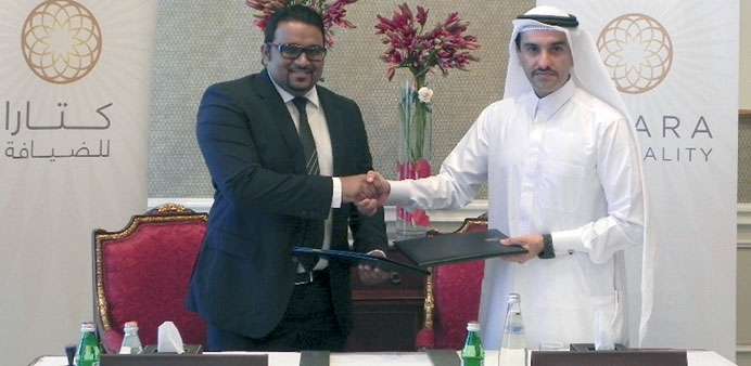 Sheikh Nawaf bin Jassim bin Jabor al-Thani shakes hands with Ahmed Adeeb Abdul Gafoor after concluding the agreement between Katara Hospitality and Ma