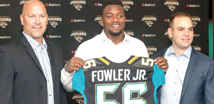 Dante Fowler (middle ) with Jaguars coach Gus Bradley (left) and general manager David Caldwell.