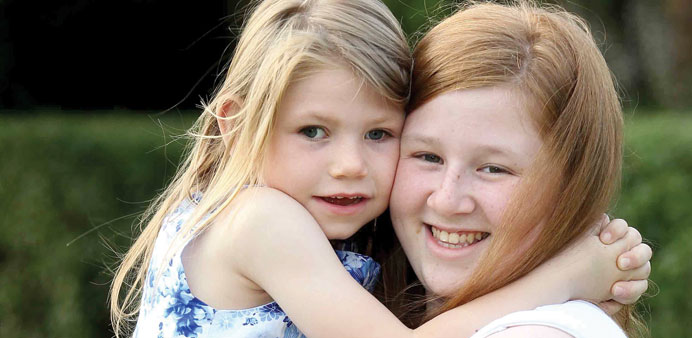 Cheyenne McLaughlin with her six-year-old sister Caitlin: special bond.