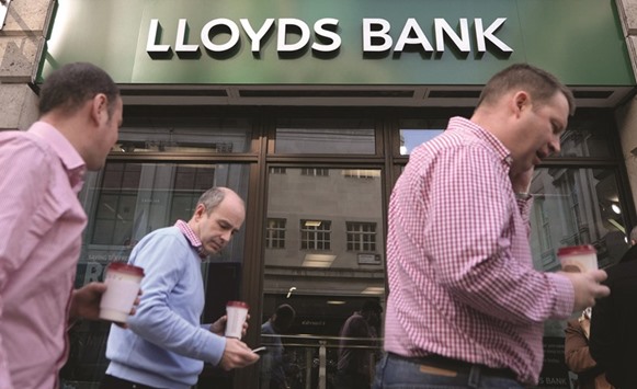 Pedestrians pass a Lloyds Bank branch in London. Lloyds has slumped about 27% in London trading this year, shaving more than u00a313bn from its market value and making it the second-worst performer among major UK banks after Royal Bank of Scotland Group.