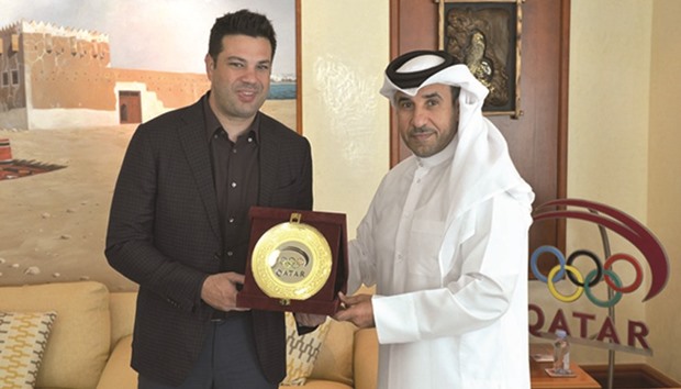 Brazilian Minister of Sport Leonardo Picciani (left) receives a memento from Qatar Olympic Committee secretary general Dr Thani al-Kuwari.