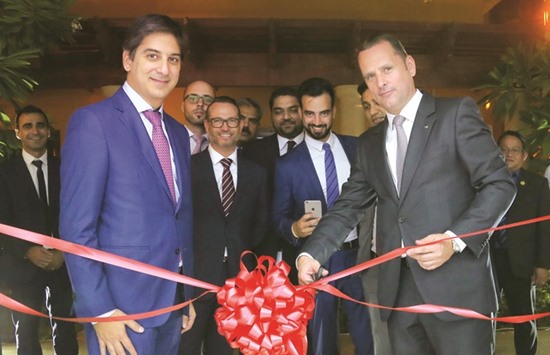Mansour and Franck Heimburger, AXA Gulf chief sales and distribution officer, join other executives during the opening of the companyu2019s new shop at The Pearl. PICTURE: Jayan Orma