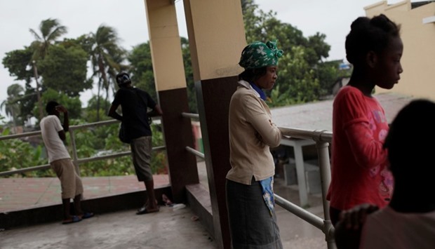 A woman looks at the courtyard in a shelter set up at the Lycee Philippe Guerrier ahead of Hurricane Matthew in Les Cayes, Haiti