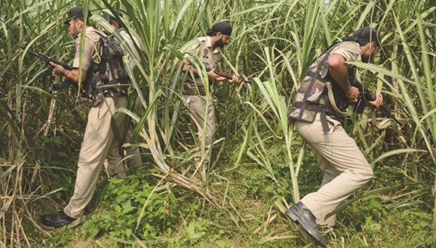 Policemen take part in search operations in a sugarcane field near the Indian-Pakistan border Chakri post, about 20km from Gurdaspur, yesterday.