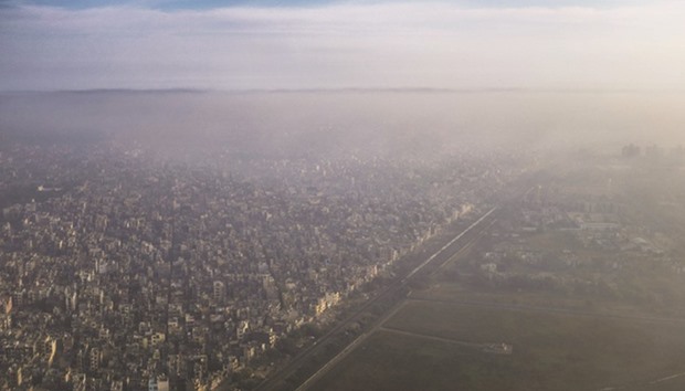 In this photograph taken on March 15, 2016, a blanket of smog extends over a densely populated neighbourhood adjacent to the main airport in New Delhi.