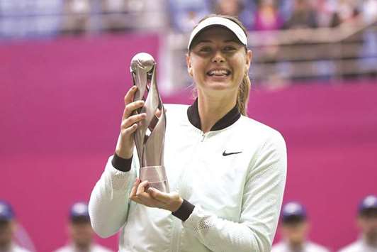 Maria Sharapova of Russia holds her trophy after beating Aryna Sabalenka of Belarus at the Tianjin Open yesterday.