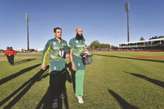 South Africau2019s Hashim Amla (right) and Quinton de Kock walk back after the win in the first one-day international against Bangladesh in Kimberley, South Africa, yesterday. (AFP)