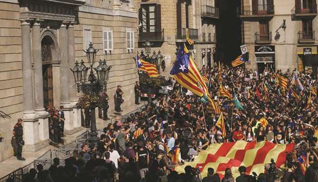 Students wave Catalan pro-independence u2018Esteladau2019 flags during a protest yesterday in front of the Generalitat Palace (Catalan government headquarters) in Barcelona. Thousands of students rallied in Barcelona yesterday in support of Catalan independence and against plans by Spainu2019s central government to curb the regionu2019s powers. The demonstrators carried red carnations and wore red and yellow Catalan  independence flags tied around their necks as they made their way through the centre of the Catalan capital, chanting u2018Occupation forces out!u2019