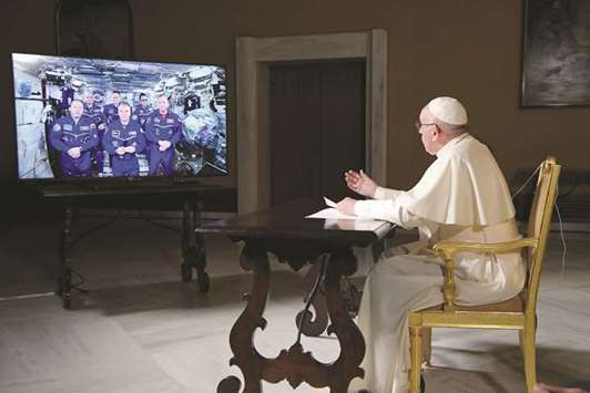 Pope Francis talks with crew members of the ISS during an audio-video connection at the Vatican.