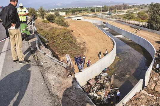 Police forensic experts examine the wreckage of the truck in Izmir.