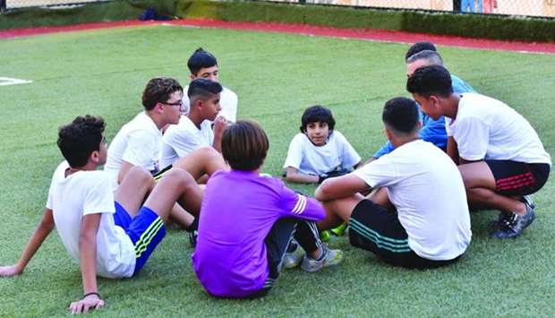 Rota goodwill ambassador Ghanim al-Muftah interacting with a group of children.