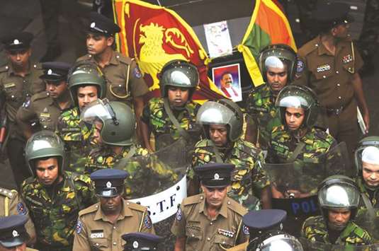 Soldiers keep watch outside the Ceylon Petroleum Corporation in Colombo yesterday.