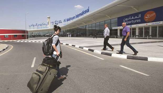 A passenger (left) walks on her way into the Dubai World Central-Al Maktoum International Airport, in Jebel Ali, Dubai (file). Al Maktoum International has already faced delays. A smaller capacity increase is a year behind schedule and is expected to be finished this year.