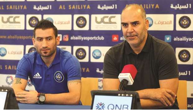 Al Sailiya coach Sami Trablesi (R) speaks to reporters at his press conference.