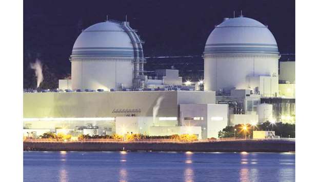 The No 3 (left), and No 4 reactor buildings stand at Kansai Electric Power Cou2019s Takahama nuclear power station at dusk in Takahama Town, Fukui Prefecture. A payoff scandal has struck Japanu2019s nuclear world, threatening to delay the restart of idled reactors in whatu2019s becoming the industryu2019s biggest crisis since the Fukushima meltdowns of 2011.