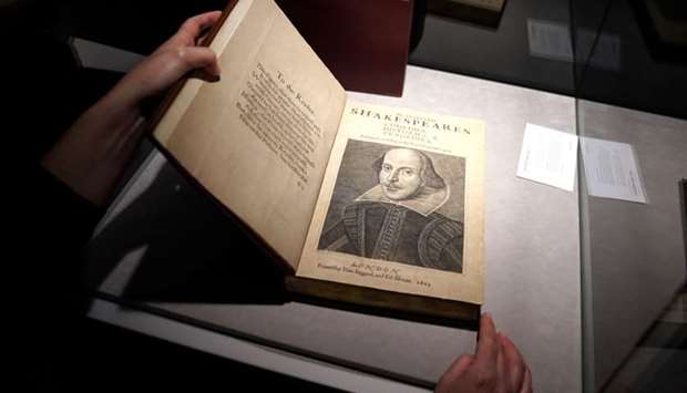 An employee of Christie's auctions holds a 1663 rare first folio of 36 Shakespeare works that was sold for a record 8.4 million dollars (9.978 million with buyers fee) in the Manhattan borough of New York City, New York, US.