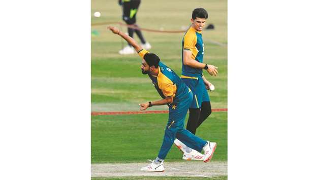 Pakistanu2019s bowler Haris Rauf (L) delivers a ball as teammate Shaheen Shah (R) looks on during a practice session at the Rawalpindi Cricket Stadium yesterday.