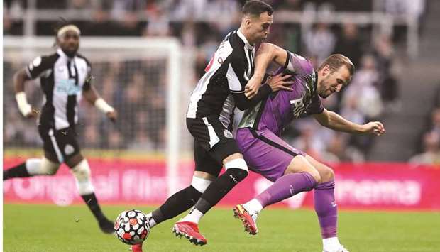 Newcastle Unitedu2019s Javier Manquillo (left) vies for the ball with Tottenham Hotspuru2019s Harry Kane during the Premier League match at St Jamesu2019 Park in Newcastle, Britain, yesterday. (Reuters)