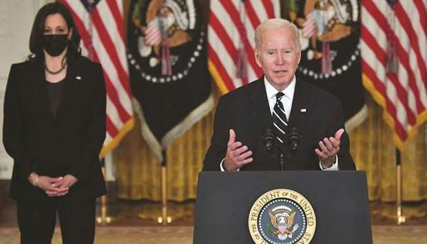 US President Joe Biden speaks about his administrationu2019s social spending plans as Vice President Kamala Harris looks on from the East Room of the White House in Washington, DC, yesterday.