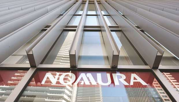 The Nomura Holdings logo is displayed outside a Nomura Securities branch in Kawasaki, Japan. Nomurau2019s profit slumped as a $343mn provision for an ongoing legal case dealt yet another blow to the brokerage thatu2019s just recovering from staggering losses linked to the collapse of Archegos Capital Management.