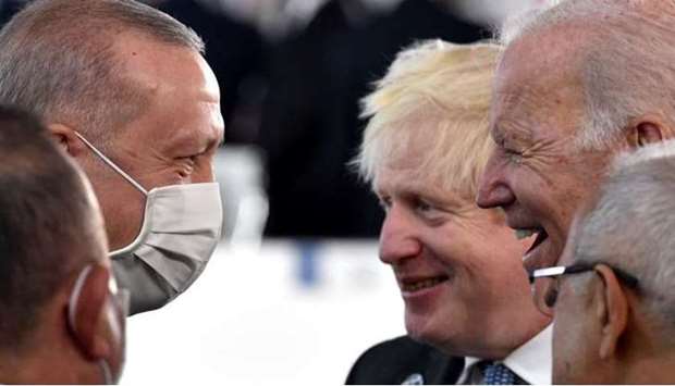 US President Joe Biden, Turkish President Recep Tayyip Erdogan and British Prime Minister Boris Johnson talk prior to the opening session of the G20 of World Leaders Summit.