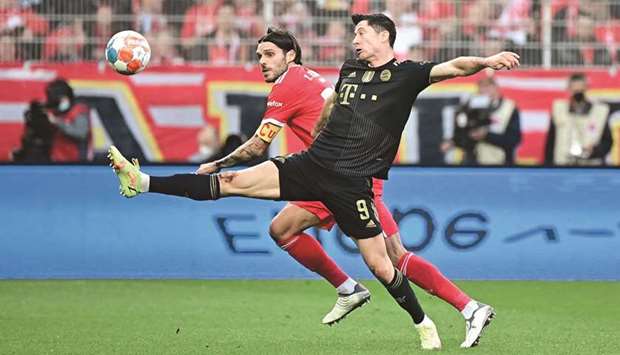 Bayern Munichu2019s Robert Lewandowski (right) and Union Berlinu2019s Christopher Trimmel vie for the ball during the Bundesliga match in Berlin. (AFP)