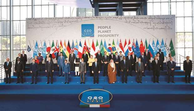 Italian Prime Minister Mario Draghi (centre-front) stands with world leaders for the official family photograph on day one of the G20 Summit at the Convention Center of La Nuvola, in the EUR district of Rome yesterday. (AFP)