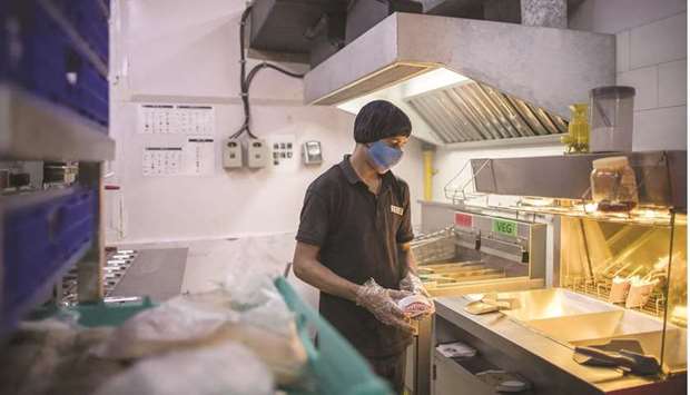 An employee makes a sandwich at the Rebel Foods Ltd cloud kitchen in Noida, India. Rebel has become at least the third Indian startup to achieve a billion-dollar valuation this week after securing $175mn in a funding round led by the sovereign wealth fund Qatar Investment Authority.