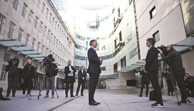 British Chancellor of the Exchequer Jeremy Hunt speaks during an interview outside the BBC headquarters, in London.