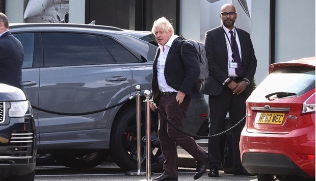 Former British Prime Minister Boris Johnson walks, at Gatwick Airport, near London, Britain. REUTERS