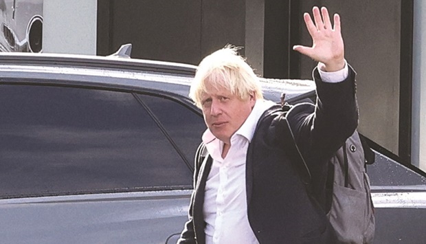 Former British Prime Minister Boris Johnson gestures, at Gatwick Airport, near London, yesterday.