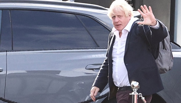 Former British Prime Minister Boris Johnson walks, at Gatwick Airport, near London, Britain Saturday. REUTERS