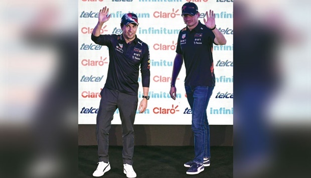 Red Bull Racingu2019s Sergio Perez (left) and Max Verstappen wave during an event with fans at the Museo Soumaya in Mexico City. (AFP)