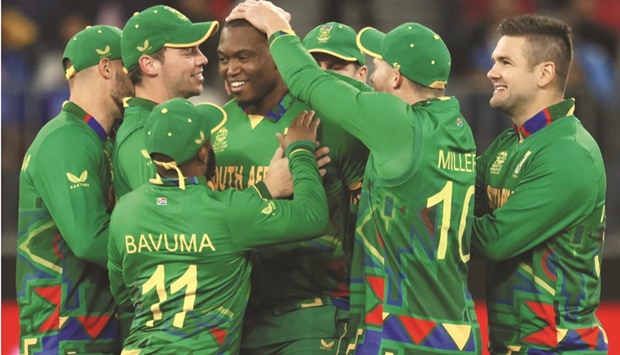 South Africau2019s Lungi Ngidi (centre) celebrates with teammates after taking the wicket of Indiau2019s captain Rohit Sharma during the ICC Twenty20 World Cup 2022 match at the Perth Stadium yesterday. (AFP)