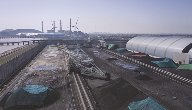 A coal depot near a power station in Jiaxing, Zhejiang province. China is building a vast array of new coal-fired power stations, potentially more than the operating capacity of the US, even though it knows the plants will probably never be fully used.