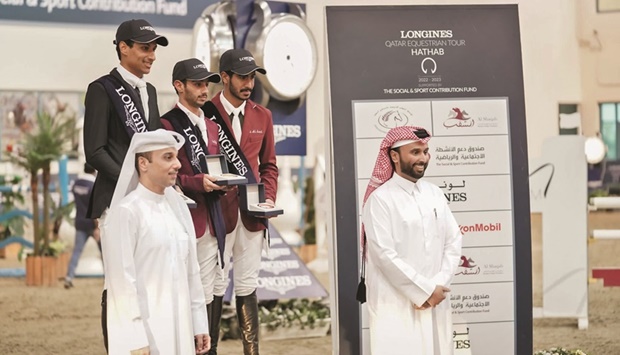 Small Tour winner Mohamed Nasser al-Qadi, runner-up Saif Mohamed al-Kaabi and third-placed Saeed Hamad Jumaa pose on the podium with Supreme Organising Committee vice-president Omar al-Mannai (front left) during the Qatar Equestrian Tour u2013 Longines Hathab at the Qatar Equestrian Federationu2019s Indoor Arena.