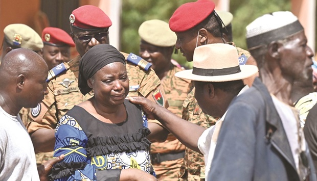 Family members gather during the funeral of the killed soldiers in Ouagadougou.