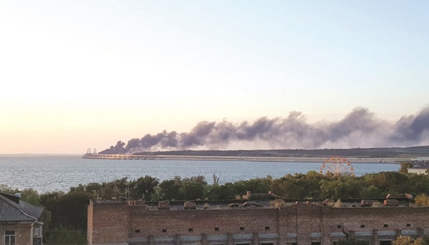 The photograph above shows thick black smoke rising from a fire on the Kerch bridge that links Crimea to Russia, after a truck exploded.