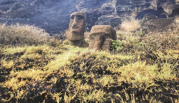 Damaged Moai statues are seen after a wildfire at a local park in Easter Island, Chile, in this undated handout photo obtained by Reuters.