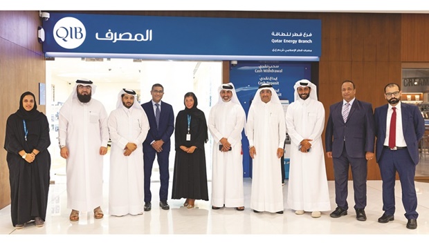 QIB senior team in front of the new QatarEnergy branch.