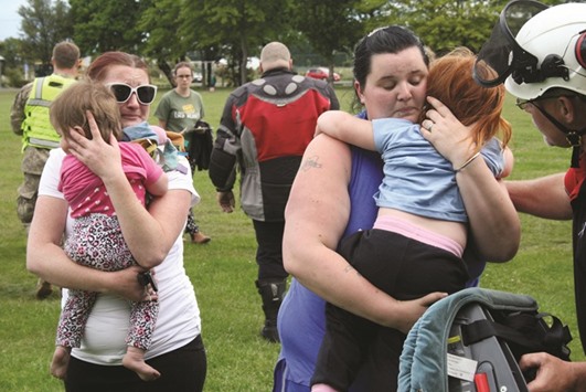 Evacuees from the earthquake-affected town of Kaikoura disembark from a helicopter in the town of Woodend, near Christchurch, New Zealand.