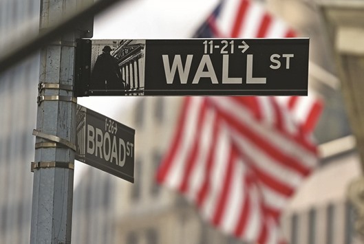 A Wall Street road sign is seen near the New York Stock Exchange building. With president-elect Donald Trump promising to spend as much as half a trillion dollars on infrastructure and slash taxes,  Wall Street is far more focused on who will next head the US Treasury than it was in the previous selection process under President Barack Obama.