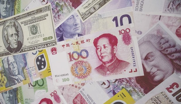 Yuan , US dollar and euro banknotes are seen outside a foreign exchange shop in Hong Kong. Chinau2019s foreign exchange reserves fell $45.7bn last month to $3.121tn, the biggest monthly decline since January, compared with a near $19bn fall in September, PBoC data showed yesterday.