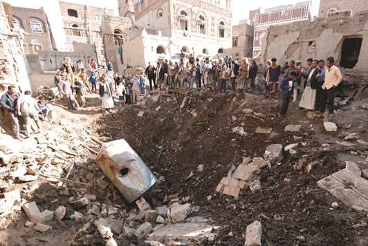 People look at the damage in the aftermath of an air strike in the Yemeni capital of Sanaa yesterday. The Saudi-led military coalition carried out two air strikes on the defence ministry in Yemenu2019s rebel-held capital Sanaa late on Friday, witnesses said.