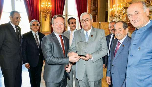 QBA first deputy to the chairman Hussein Alfardan and Minister of State attached to the Minister for Europe and Foreign Affairs, Jean-Baptiste Lemoyne, shake hands during the awarding of a token of recognition.